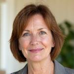 Portrait of Dr. Evelyn Reed, a cheerful woman with warm eyes and a professional demeanor, looking directly at the camera.